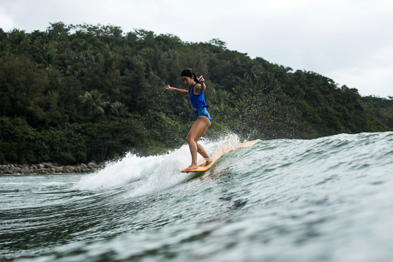 person flying off a surfboard into the waves